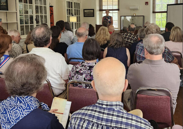 A roomful of seated people attend the LMHS Annual Meeting