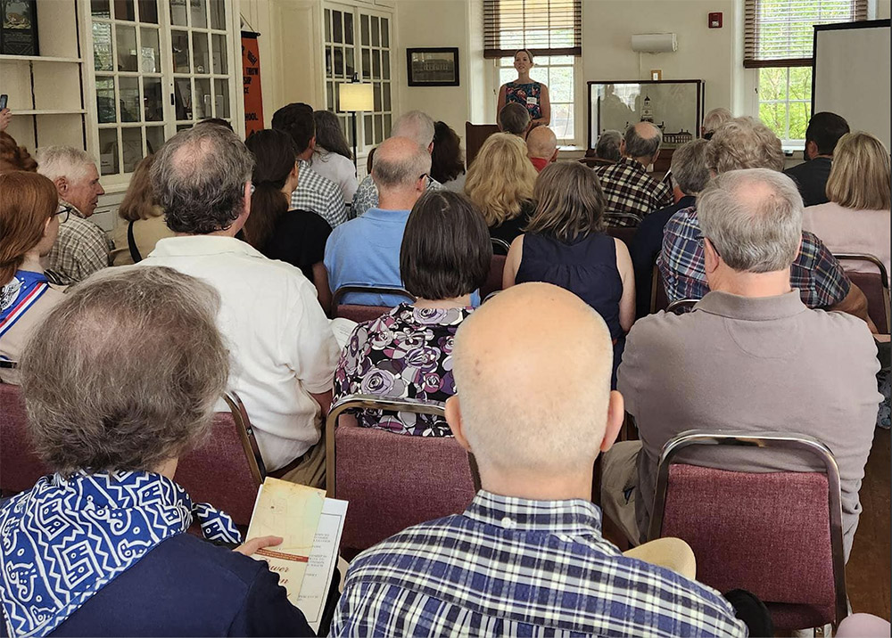 A roomful of seated people attend the LMHS Annual Meeting
